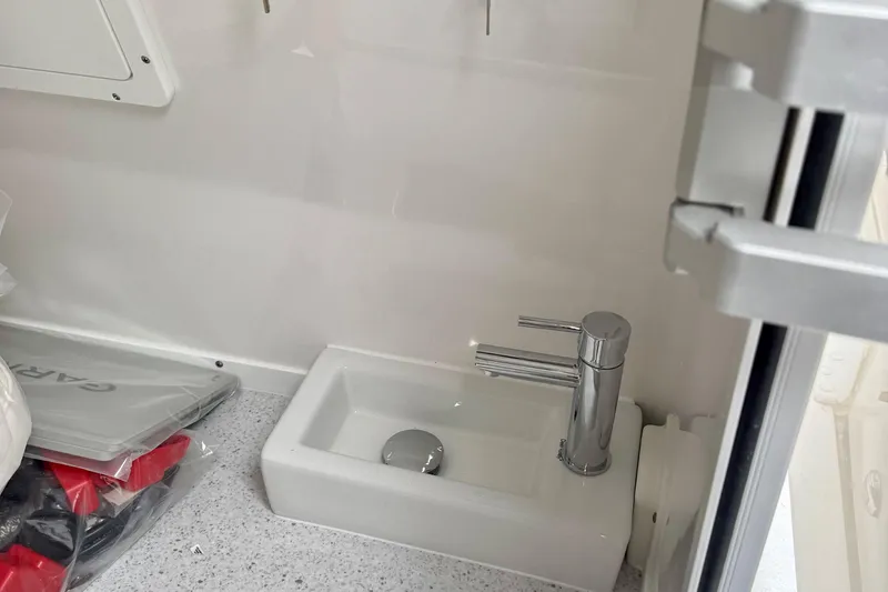 Slide: The Image of Control panel of 2026 Tidewater 302 CC Adventure boat with switches and keys. - 50