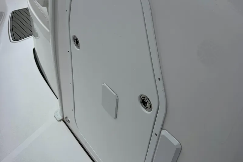 Slide: The Image of 2026 Tidewater 302 CC Adventure boat interior with storage compartment and window. - 53