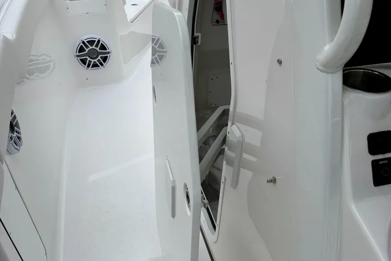 Slide: The Image of 2026 Tidewater 302 CC Adventure boat storage compartment, partially open, showcasing sleek design. - 55