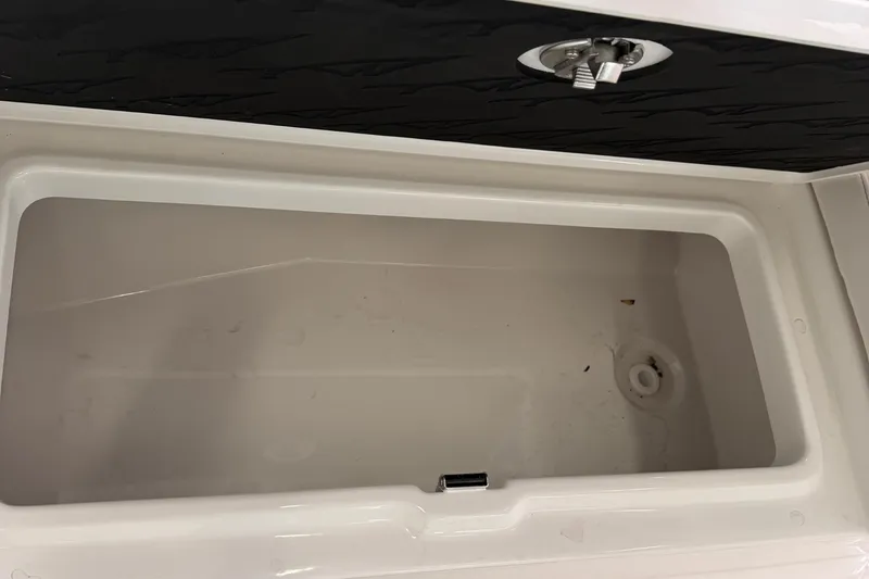 Slide: The Image of 2026 Tidewater 302 CC Adventure boat interior seating with cup holder and storage. - 63