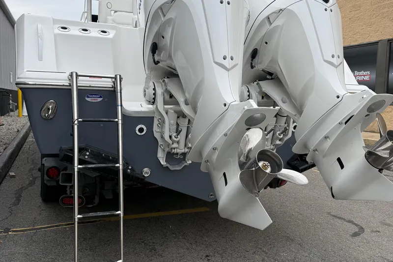 Slide: The Image of 2026 Tidewater 302 CC Adventure boat on trailer, featuring Yamaha engines, parked outdoors. - 8