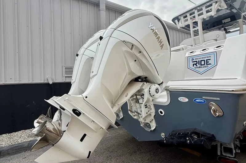 Slide: The Image of 2026 Tidewater 302 CC Adventure boat with dual outboard motors and ladder. - 9