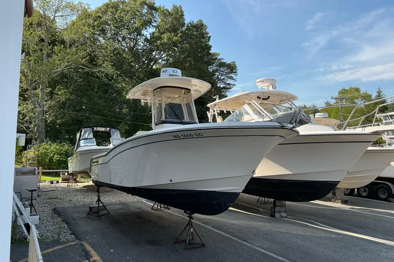 Slide: The Image of 2023 Grady-White Fisherman 236 boats on display in a marina setting. - 1