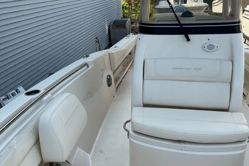 Slide: The Image of 2023 Grady-White Fisherman 236 boat interior with white seating and console. - 7