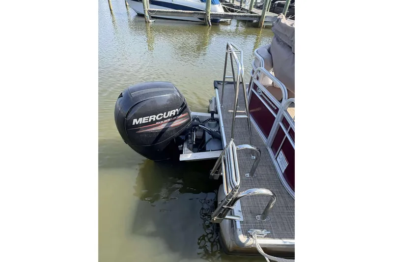 Slide: The Image of 2018 Princecraft Vectra 25 pontoon boat with Mercury outboard motor docked in water. - 13