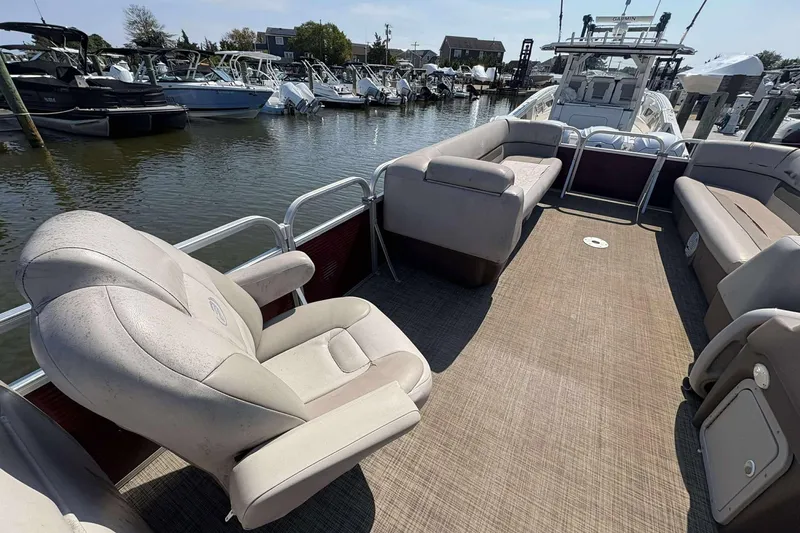 Slide: The Image of 2018 Princecraft Vectra 25 pontoon boat with spacious seating at a marina. - 7