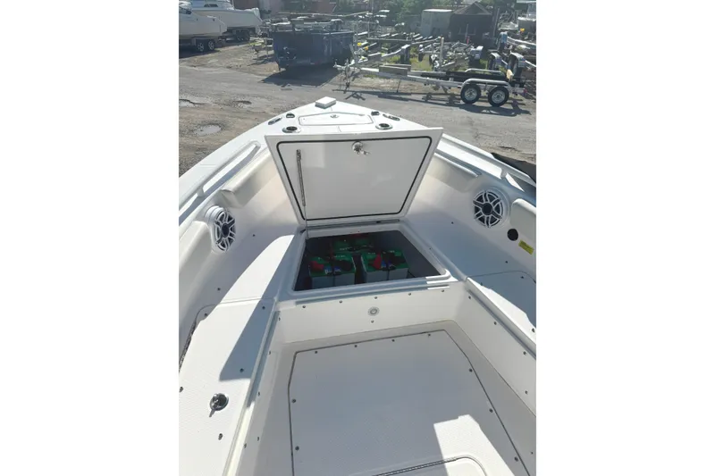 Slide: The Image of 2022 Everglades 243 Center Console boat with open storage compartment and speakers. - 11