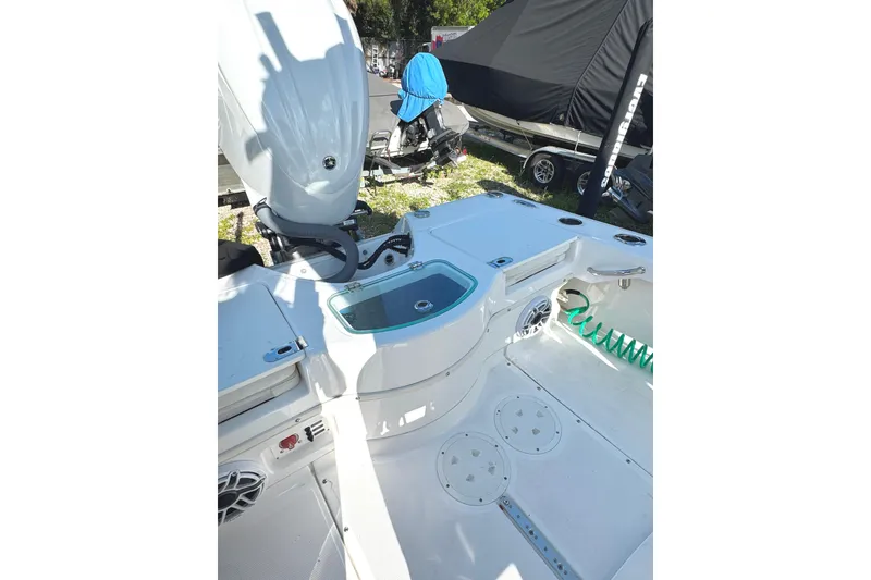 Slide: The Image of 2022 Everglades 243 Center Console boat interior with engine and storage compartments. - 14