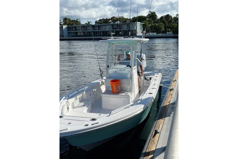 Slide: The Image of 2022 Everglades 243 Center Console boat docked on a sunny day. - 2