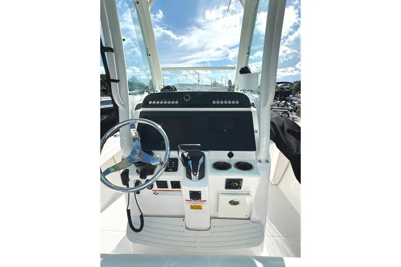 Slide: The Image of 2022 Everglades 243 Center Console boat dashboard with steering wheel and controls. - 21