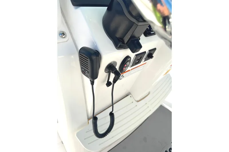Slide: The Image of Control panel of 2022 Everglades 243 Center Console boat with microphone and outlets. - 25
