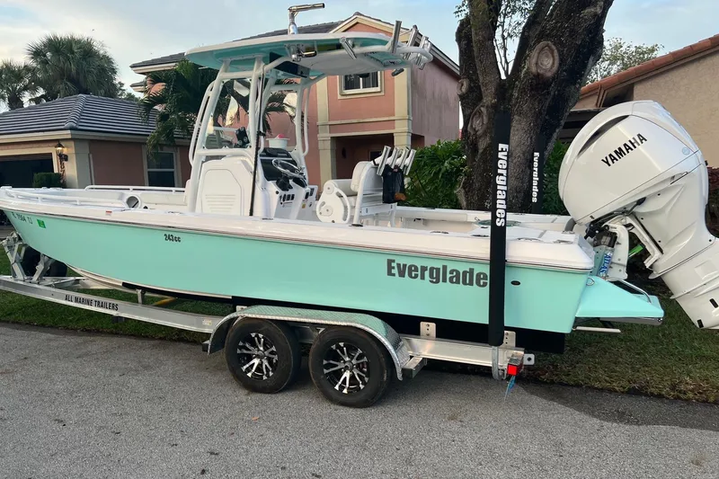Slide: The Image of 2022 Everglades 243 Center Console boat on trailer, parked in residential area. - 3