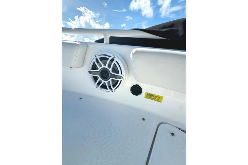 Slide: The Image of Speaker and seating area on 2022 Everglades 243 Center Console boat under blue sky. - 34