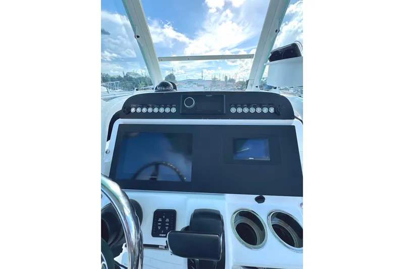 Slide: The Image of 2022 Everglades 243 Center Console boat dashboard with modern navigation displays. - 8