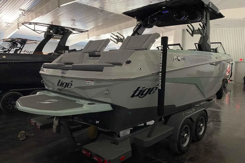Slide: The Image of 2026 Tigé Z3 boat on trailer in showroom, featuring sleek design and modern amenities. - 2