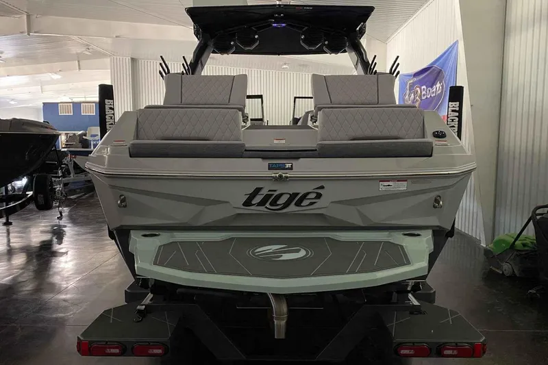 Slide: The Image of 2026 Tigé Z3 boat in showroom, rear view with seating and swim platform. - 3