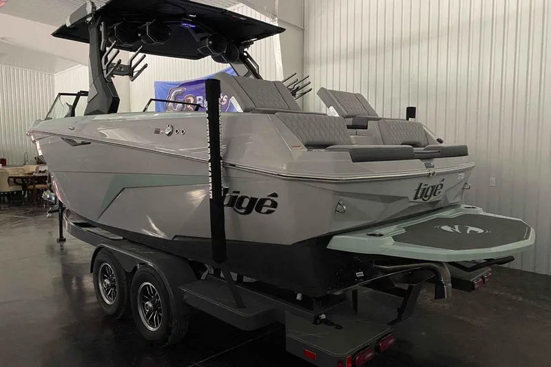 Slide: The Image of 2026 Tigé Z3 boat on trailer in indoor showroom, showcasing sleek design and modern features. - 4