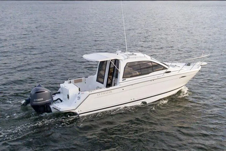 Slide: The Image of Manufacturer Provided Image: 2021 Cutwater C-24 Coupe boat cruising on open water. - 1