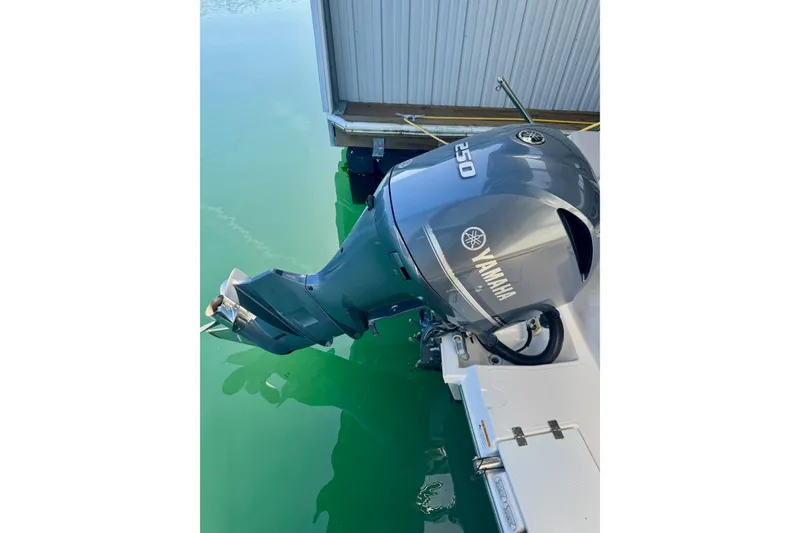 Slide: The Image of Yamaha 250 outboard motor on 2021 Cutwater C-24 Coupe, docked in clear water. - 10