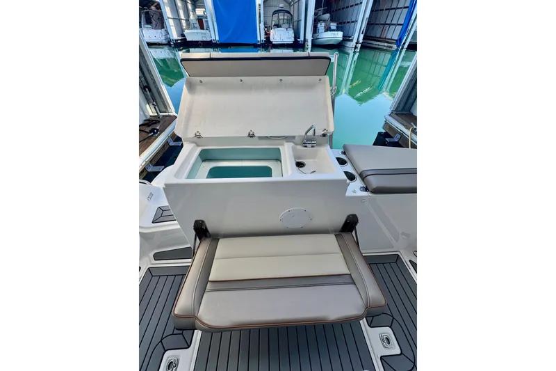 Slide: The Image of 2021 Cutwater C-24 Coupe boat interior with open storage and seating. - 14