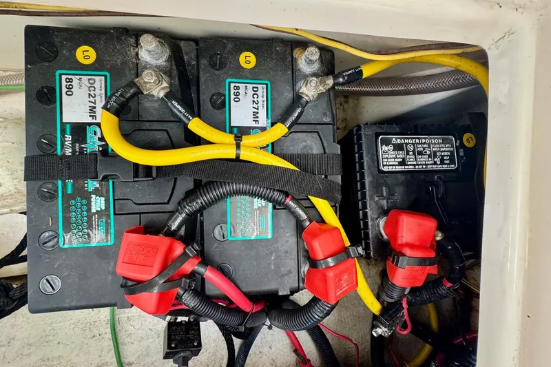 Slide: The Image of Battery compartment of a 2021 Cutwater C-24 Coupe with wiring and connectors. - 16