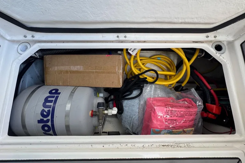 Slide: The Image of Storage compartment of 2021 Cutwater C-24 Coupe with equipment and supplies. - 17