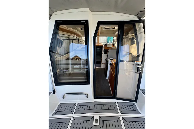 Slide: The Image of 2021 Cutwater C-24 Coupe interior view with open glass door and modern design. - 18