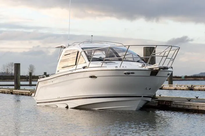 Slide: The Image of Manufacturer Provided Image: 2021 Cutwater C-24 Coupe boat docked on calm water. - 2