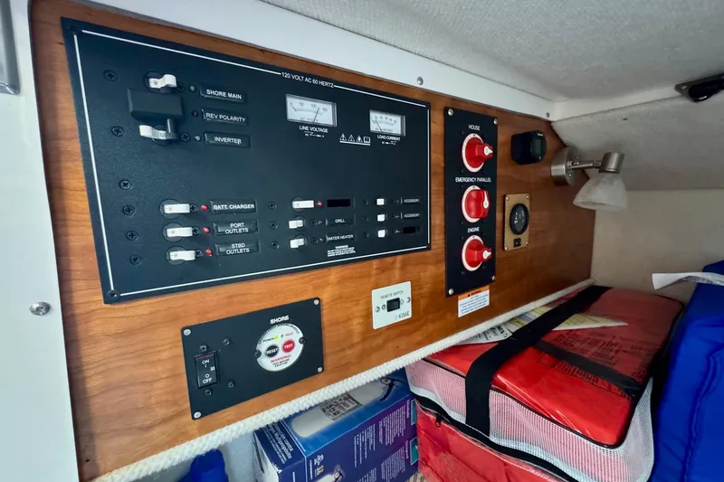 Slide: The Image of Electrical control panel inside 2021 Cutwater C-24 Coupe boat cabin, featuring switches and gauges. - 22