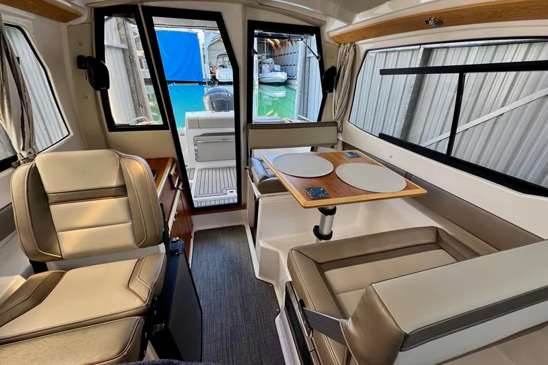 Slide: The Image of Interior of 2021 Cutwater C-24 Coupe, featuring seating and dining area with modern design. - 24