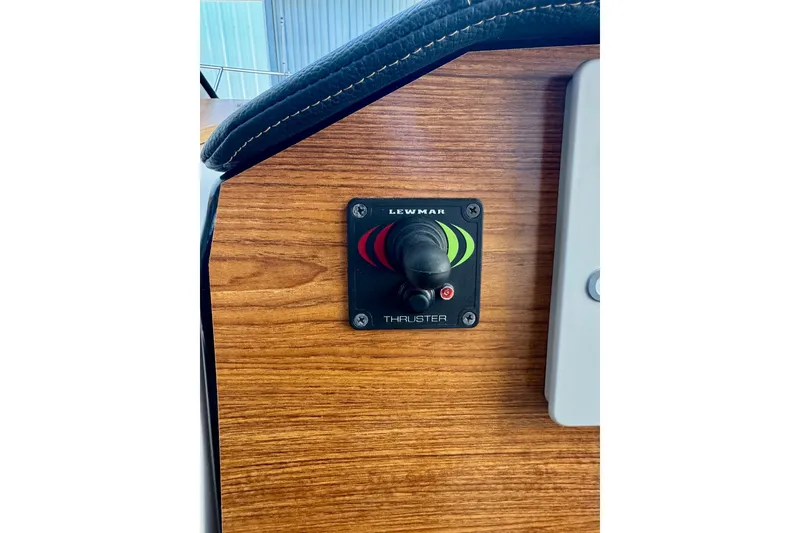 Slide: The Image of Lewmar thruster control on 2021 Cutwater C-24 Coupe's wooden dashboard. - 27