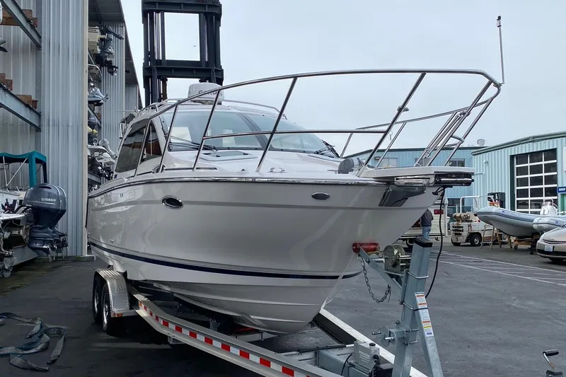 Slide: The Image of 2021 Cutwater C-24 Coupe boat on trailer at marina, side view. - 3