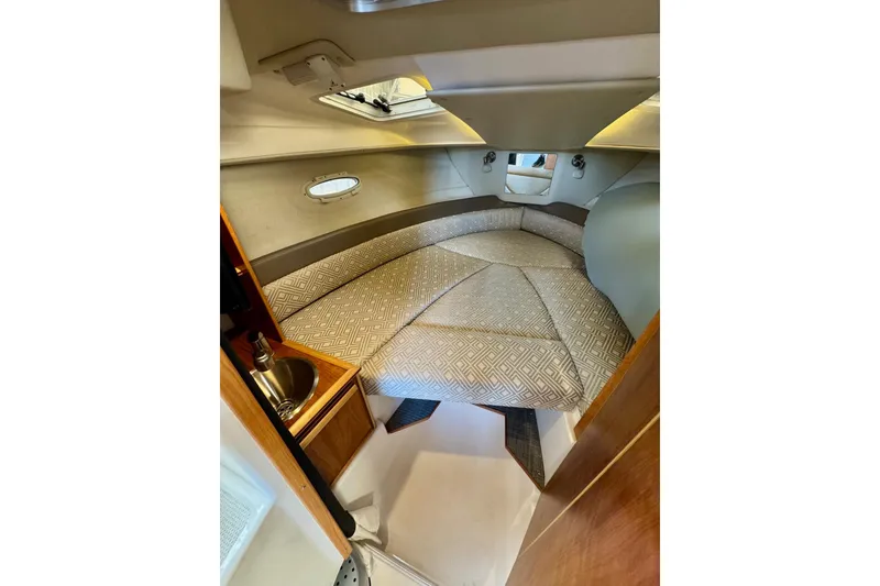 Slide: The Image of 2021 Cutwater C-24 Coupe cabin interior with cozy bed and compact sink. - 36