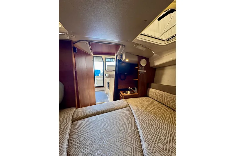 Slide: The Image of Interior of 2021 Cutwater C-24 Coupe, featuring cozy cabin with bed and kitchenette. - 38