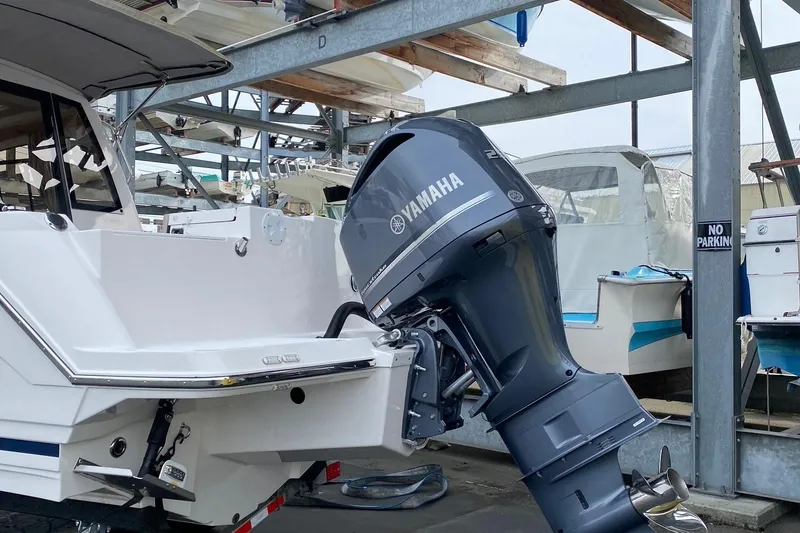 Slide: The Image of 2021 Cutwater C-24 Coupe with Yamaha outboard motor in a boat storage facility. - 4