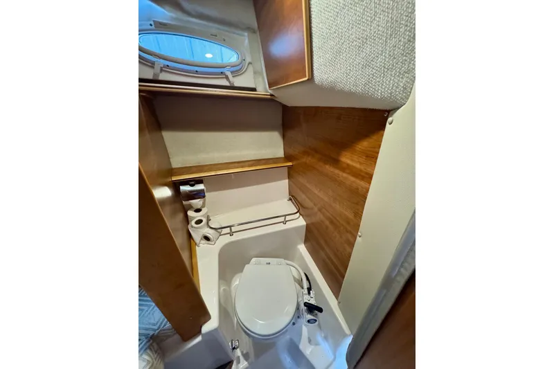 Slide: The Image of 2021 Cutwater C-24 Coupe bathroom interior with wood accents and compact design. - 41