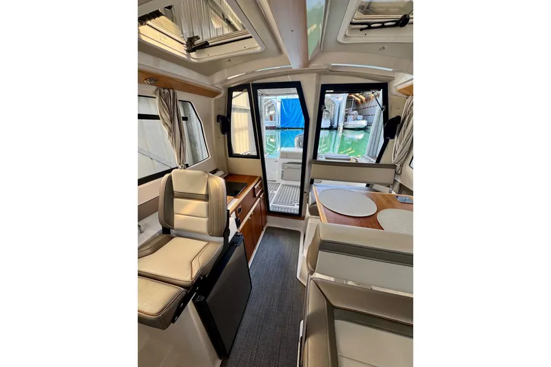 Slide: The Image of Interior of 2021 Cutwater C-24 Coupe boat with seating and dining area. - 43