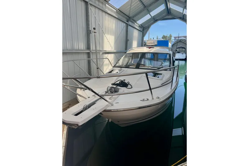 Slide: The Image of 2021 Cutwater C-24 Coupe boat docked in a covered marina. - 6