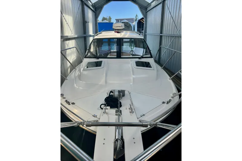 Slide: The Image of 2021 Cutwater C-24 Coupe boat docked in a covered marina. - 8