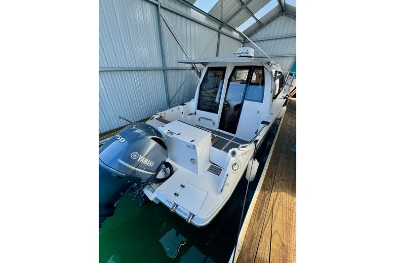 Slide: The Image of 2021 Cutwater C-24 Coupe boat with Yamaha engine, docked in a covered marina. - 9