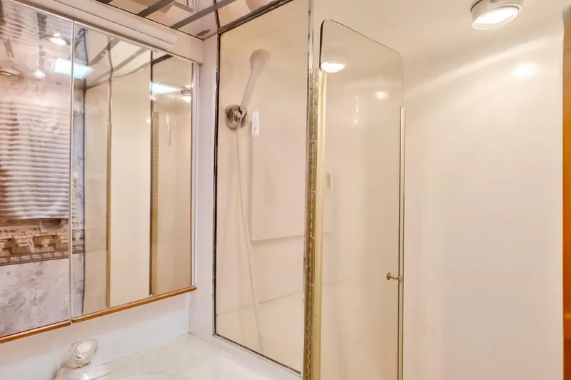 Slide: The Image of Bathroom interior of 1999 Ocean Yachts 48 Super Sport with shower and mirrored cabinets. - 11