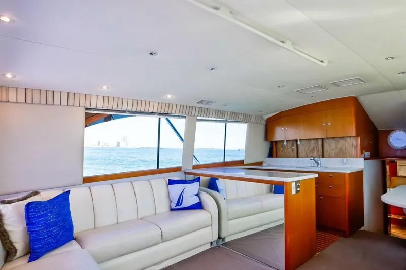 Slide: The Image of Luxurious interior of 1999 Ocean Yachts 48 Super Sport with white seating and ocean view. - 6
