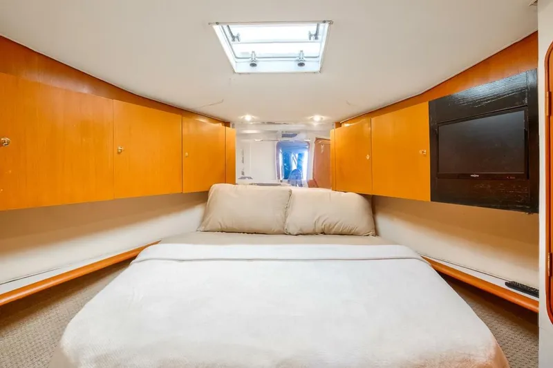 Slide: The Image of Luxurious cabin interior of 1999 Ocean Yachts 48 Super Sport with cozy bed and wooden cabinets. - 9