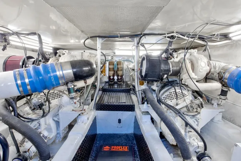 Slide: The Image of Engine room of 1999 Ocean Yachts 48 Super Sport, showcasing dual engines and mechanical components. - 18