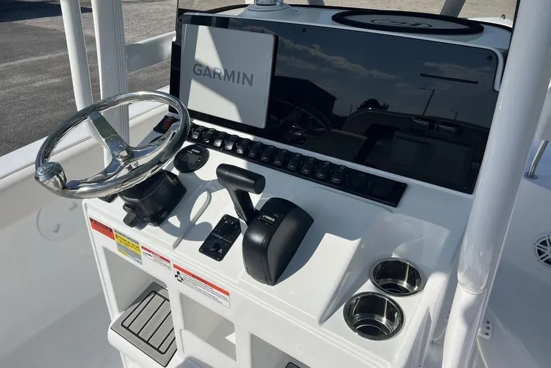 Slide: The Image of 2026 Sea Hunt Ultra 219 boat console with Garmin display and steering wheel. - 11