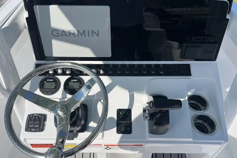 Slide: The Image of 2026 Sea Hunt Ultra 219 boat dashboard with Garmin display and Yamaha controls. - 12