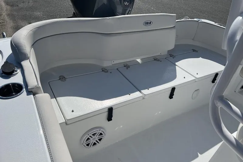 Slide: The Image of 2026 Sea Hunt Ultra 219 boat interior with cushioned seating and storage compartments. - 15