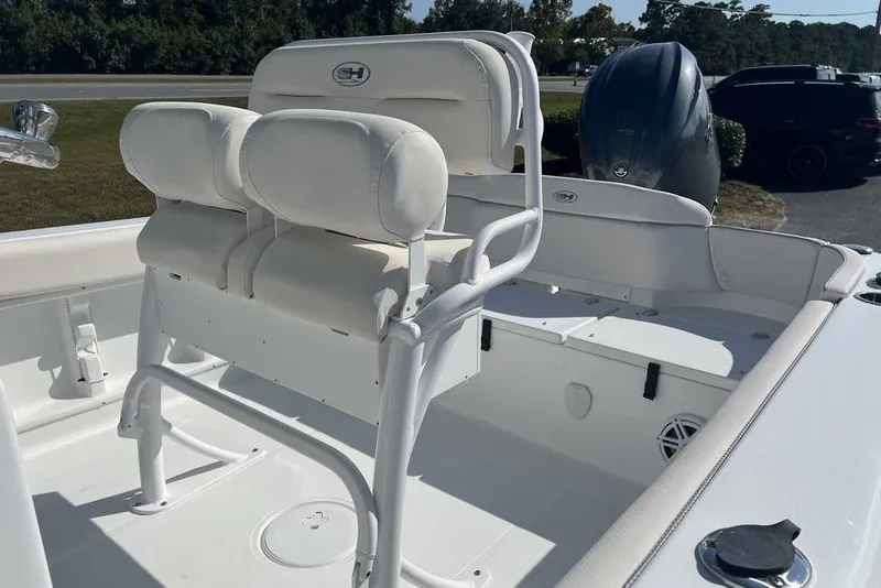 Slide: The Image of 2026 Sea Hunt Ultra 219 boat interior with white seating and console. - 17