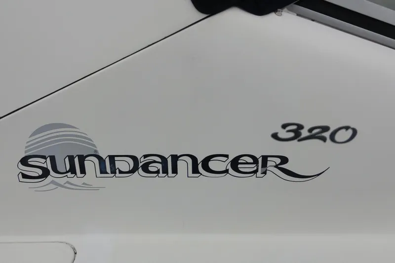 Slide: The Image of 2004 Sea Ray 320 Sundancer logo on boat exterior. - 1