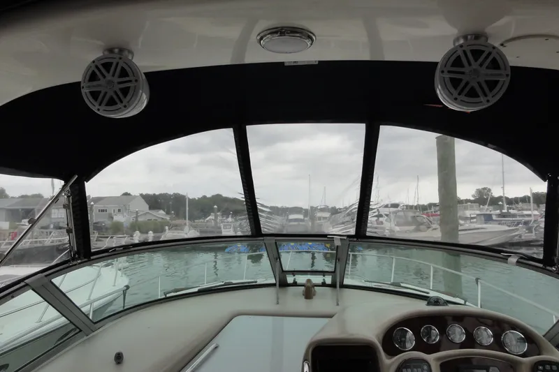 Slide: The Image of Interior view of 2004 Sea Ray 320 Sundancer boat cockpit at marina. - 11